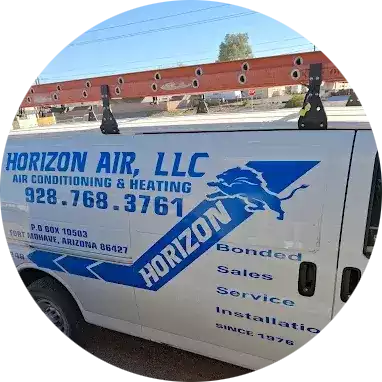 A white service van with a ladder on top displays 